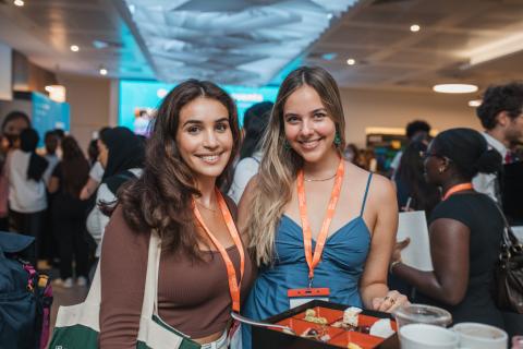 Two Bright Network members smile at an event